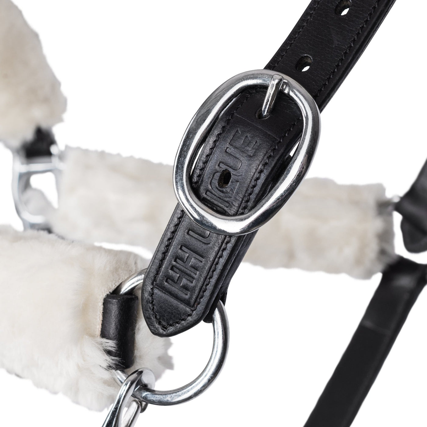 Luxury Real Leather Halter complete with detachable cream wool artificial sheepskin protection tabs. Helping to prevent chafing and irritation during travel with the sheepskin fibres also wicking moisture and providing a cushioning for ultimate comfort to your horse. Luxury soft leather Head Collar. Chic HH Unique Leather Stamped Branding; finished with quality stainless steel hardware. Ideal for sensitive ponies and horses